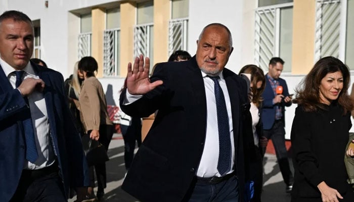 The head of the GERB party and former prime minister Boyko Borisov (centre) greets supporters after voting in Bulgaria’s parliamentary elections at a polling station in Sofia. —AFP/File