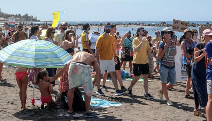 Waving white, blue and yellow flags of the Canary Islands, chanting and whistling protesters slow-marched by tourists sitting in outdoor terraces in Playa de las America in Tenerife before they rallied on the beach.— AFP/File