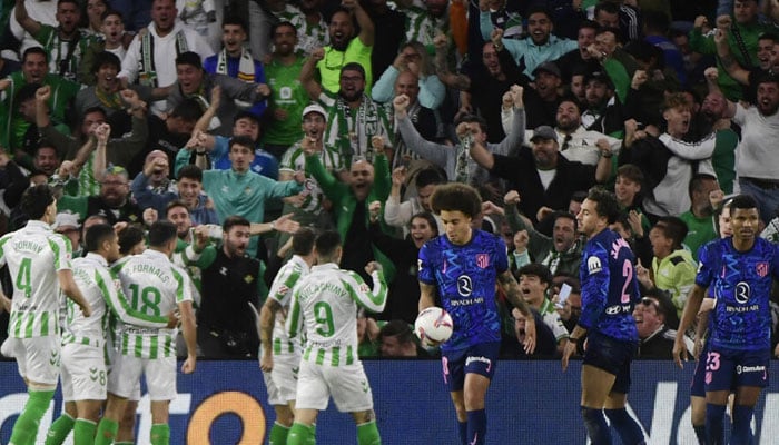 Betis players celebrate an own goal scored by Atletico Madrids Uruguayan defender Jose Gimenez (2nd right). — AFP/File