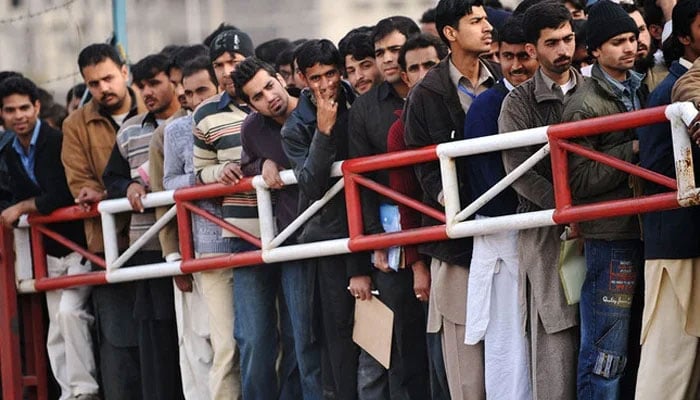 This representational image shows people waiting for a job entry test in Islamabad. — AFP/File