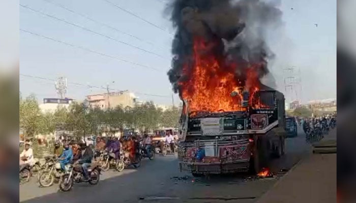 View of a burning dumper, which was torched by an angry mob after an accident killed a motorist, at North Karachi in Karachi on October 28, 2024. — PPI