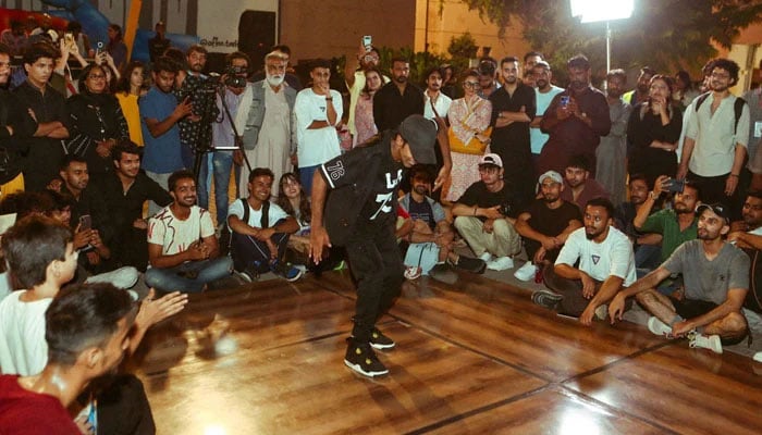 Youth are seen watching a boy dancing at the World Culture Festival in Karachi on Oct 25, 2024. — Facebook@ACPKHI