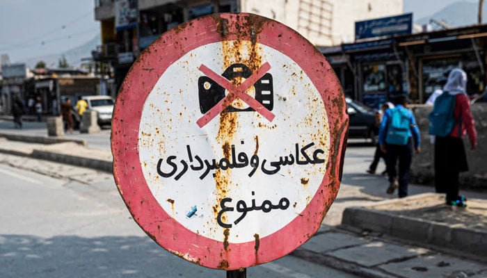 A signboard with the warning photography and video recording forbidden is displayed along a street in Kabul on October 22, 2024. — AFP