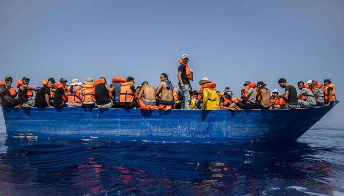 A file picture shows a group thought to be migrants from Tunisia aboard a precarious wooden boat waiting to be assisted by a team of the Spanish NGO Open Arms, around 30 kilometres southwest from the Italian island of Lampedusa, Italy. — AFP/File