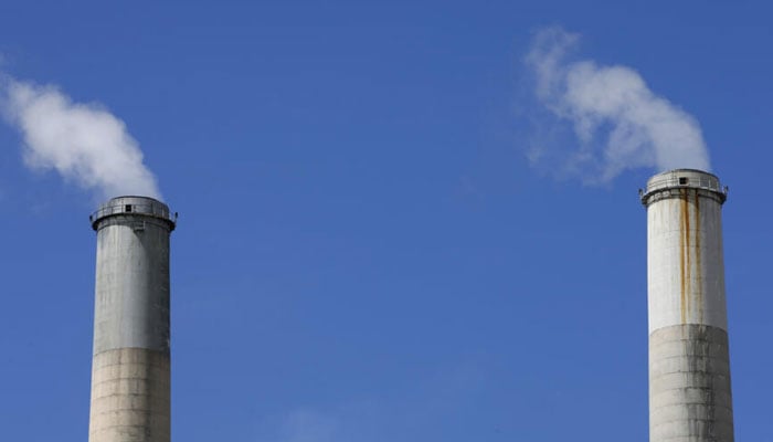 Two chimneys emitting greenhouse gases can be seen in this picture. — AFP/File