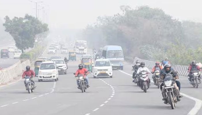 Vehicles on road in foggy environement can be seen in this picture. —ANI/File