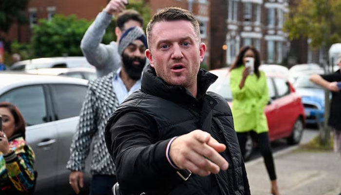 Anti-immigration activist Stephen Yaxley-Lennon, known as Tommy Robinson, gestures before arriving at Folkestone Police Station in Folkestone, Britain on October 25, 2024.— Reuters