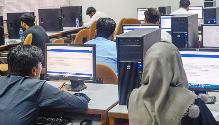 This representational image shows students attempting a computer-based test. — water.muet.edu.pk/file