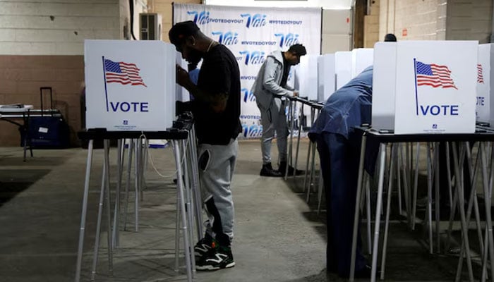 Voters fill out their ballots for the presidential election during early voting ahead of the polls closing at the Detroit Elections Office in Detroit, Michigan, US. — Reuters/File