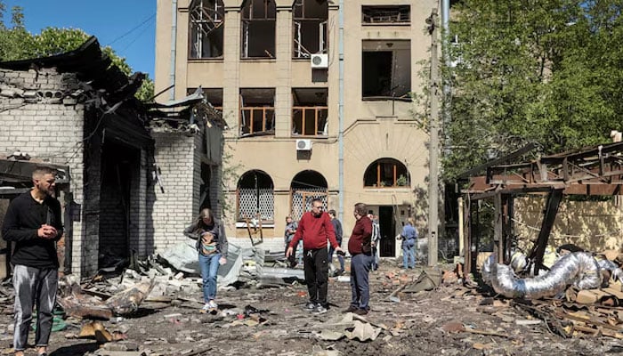 Local residents look at damage at a site of a Russian missile strike, amid Russias attack on Ukraine, in Kharkiv, Ukraine  on April 30, 2024. — Reuters