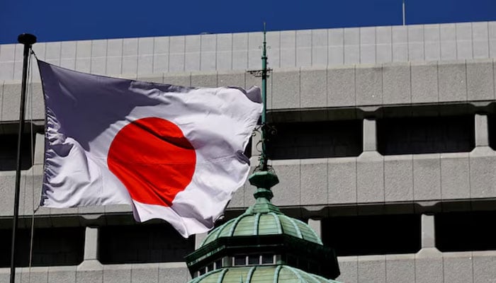 The Japanese national flag waves at the Bank of Japan building in Tokyo, Japan on March 18, 2024. — Reuters