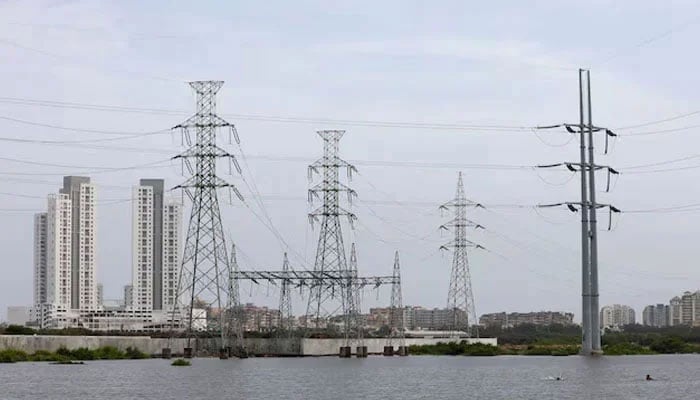 Power transmission towers are pictured in Karachi on July 26, 2022. — Reuters