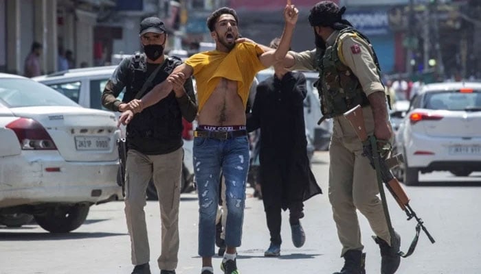 Indian policemen detain a Kashmiri youth in Srinagar, Indian Illegally Occupied Jammu and Kashmir (IIOJ&K). — AFP/File