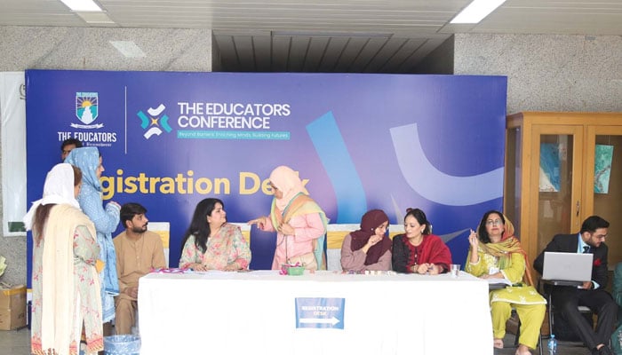 Teachers sitting on registration desk in THE EDUCATORS CONFERENCE. — Facebook@theeducatorsschoolofficial/File