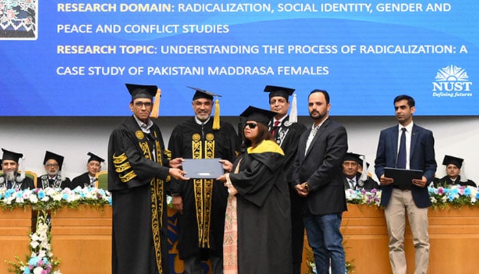 Federal Minister for Science & Technology Dr Khalid Maqbool Siddiqui as a chief guest awards a degree to a distinction holder at the “Master Convocation Ceremony,” at the NUST on October 30, 2024. — Facebook@nustofficial