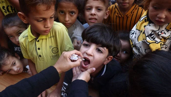 A medic administers a polio vaccine to a child. — AFP/File