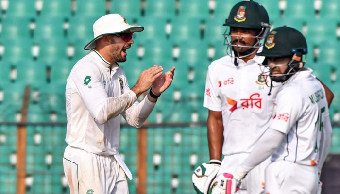 South Africa captain Aiden Markram (left) celebrates the dismissal of Bangladesh batter Mushfiqur Rahim (right) on the third day of their second Test at the Zahur Ahmed Chowdhury Stadium in Chattogram on Oct 31, 2024. — AFP