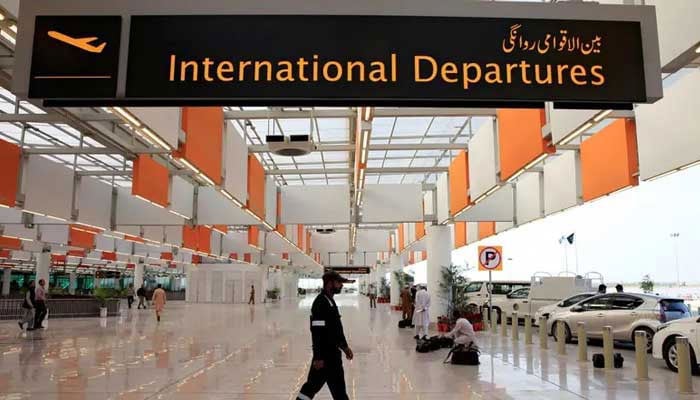 An airport staffer walks past the entrance of international departures at the Islamabad airport. — Reuters/File