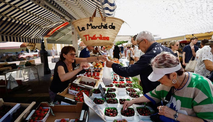 Shoppers buy fruits at a local market in Nice, France, June 8, 2023. — Reuters