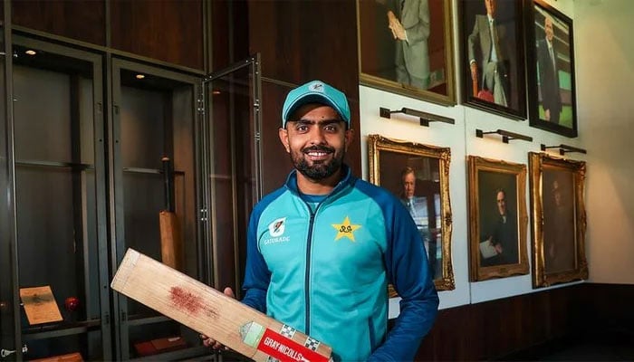 Babar Azam poses with his bat at the MCG cricket legends bat gallery. — Reporter/file