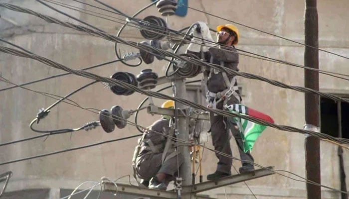 The representational image shows a worker repairing the high-voltage wires on a pole on February 20, 2024. — Online