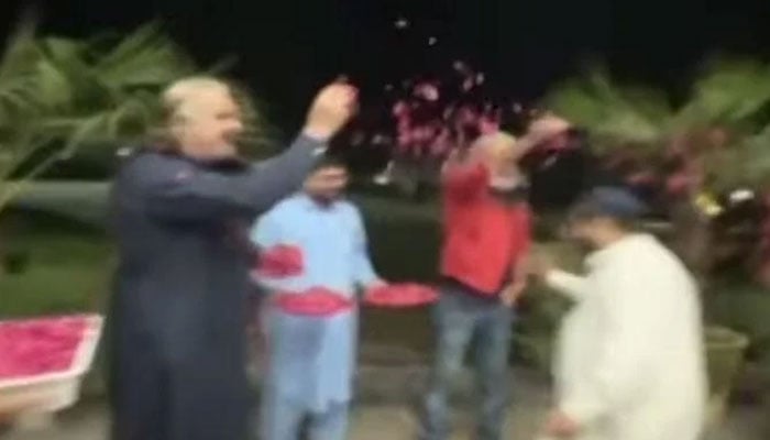 KP CM Ali Amin Gandapur shower flowers petals on a rescue personnel. — Screengrab via YouTube/Geo News