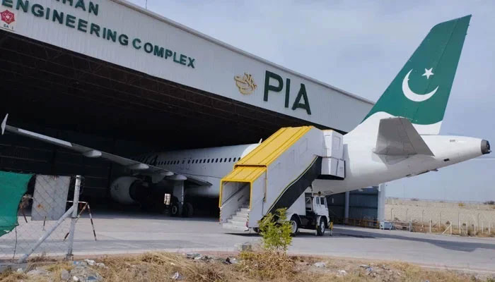 This picture released on February 9, 2023, shows Pakistan International Airlines (PIA) aircraft parked inside a shade in Nur Khan Engineering Complex in Islamabad. — X@PIA