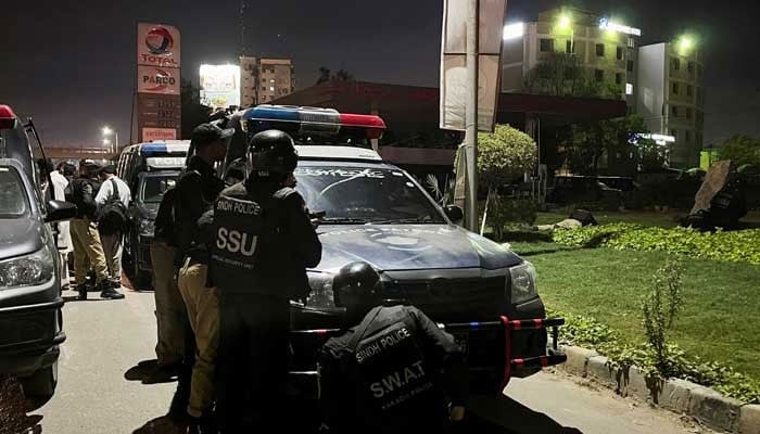 This representational image shows police officers taking position after a police office building was attacked by gunmen in Karachi on February 17, 2023. — Reuters