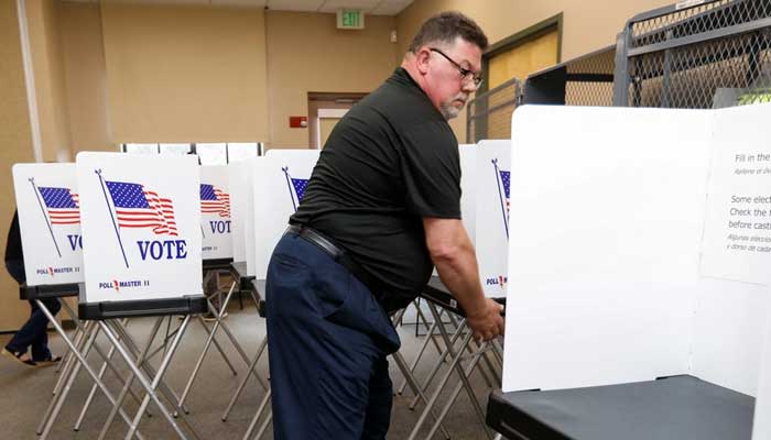 Poll workers with the Hillsborough County Supervisor of Elections Office in Seffner, Floria, setting up early voting equipment on August 2, 2024. — Reuters