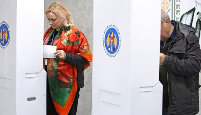 People vote at a polling station during the second round of the presidential election in Chisinau, Moldova on November 3, 2024. — Reuters