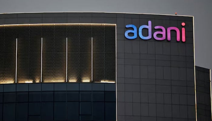 The logo of the Adani Group is seen on the facade of one of its buildings on the outskirts of Ahmedabad, India on April 13, 2021.— Reuters