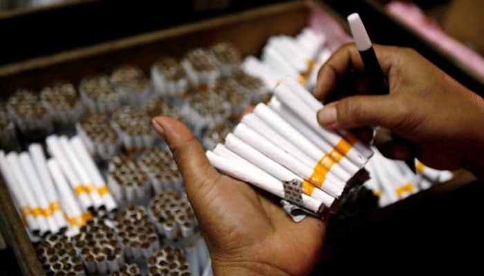 Cigarettes seen in a persons hand. — Reuters/file