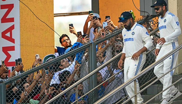 Indias Virat Kohli (R) and captain Rohit Sharma arrive for the second innings on the second day of the third Test cricket match between India and New Zealand at the Wankhede stadium in Mumbai on November 2, 2024. — AFP