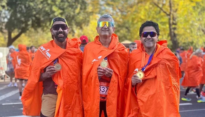 Dr Salman Khan (right), Fasih Ul Saleh and Yawar Siddiqui (left) pose with their medals. — Reporter