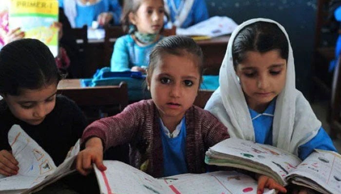 This undated photo shows students reading their books in their class — AFP/File