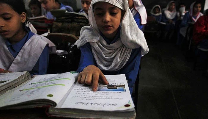 This representational image shows a student reading a book in a classroom. — Reuters/File