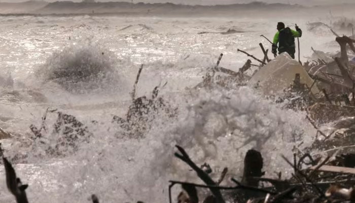 A volunteer walks as he looks for victims of the destruction on the shores of the Mediterranean Sea at the Saler beach, following heavy rains that caused floods, in El Saler, near Valencia, Spain, on Nov 4, 2024. — Reuters