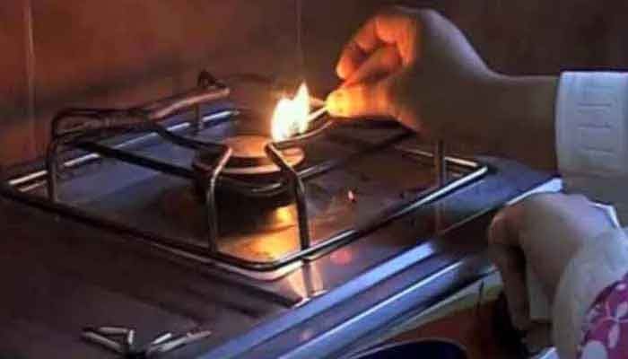 A woman is seen lighting the gas stove. Photo: The News/File