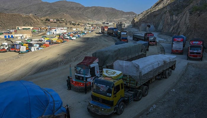 In this picture, trucks are seen parked along a road in between mountains. — AFP/File