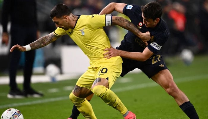 Lazio’s Italian forward Mattia Zaccagni (L) fights for the ball with Juventus Italian defender Andrea Cambiaso during the Italian Serie A football match between Juventus and Lazio. —AFP/File