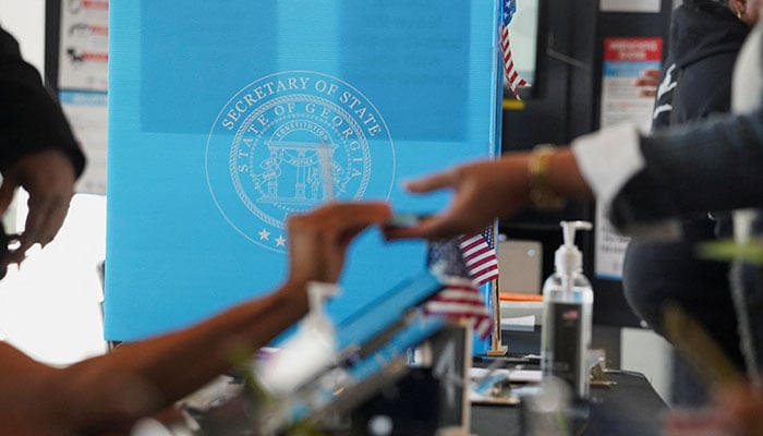 People vote at a polling station as Georgians turned out a day after the battleground state opened early voting, in Atlanta, Georgia, US on October 16, 2024.— Reuters