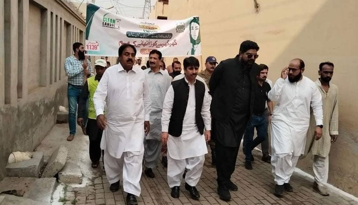 LWMC Chief Executive Officer Babar Sahib Din (from left to 3rd) and MPA Rashid Minhas (from left to 2nd) participate in a public awareness walk at Halloki village on November 6, 2024. — Facebook@Rana Rashid Minhas