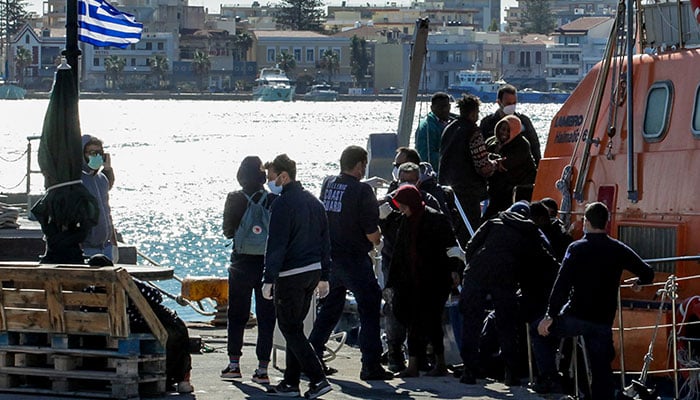 Migrants disembark a Hellenic Coast Guard vessel after being rescued at open sea, on the island of Chios, Greece on October 26, 2021. — Reuters