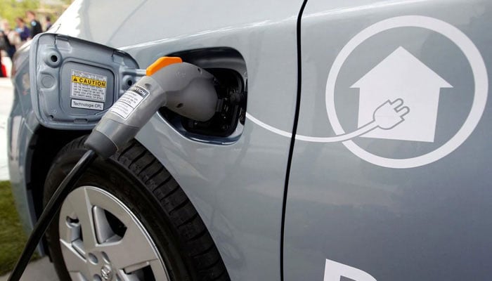 A representational image of an electric vehicle being charged at a charging station. — Reuters/File