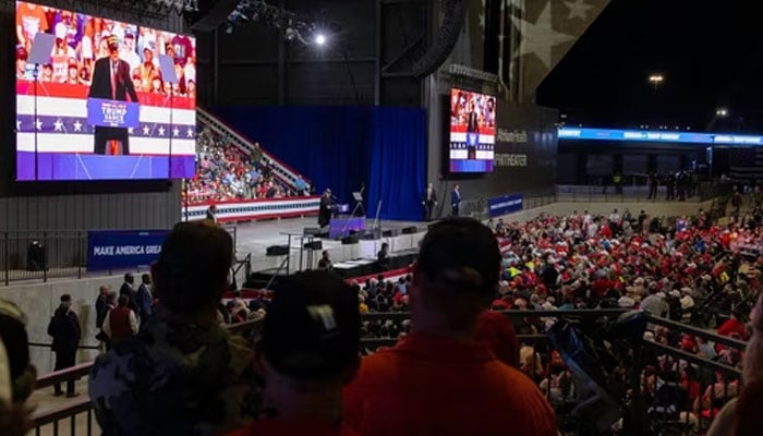 Supporters of President-elect Donald Trump listening him at a rally at the Atrium Health Amphitheater on November 03, 2024 in Macon, Georgia.—AFP