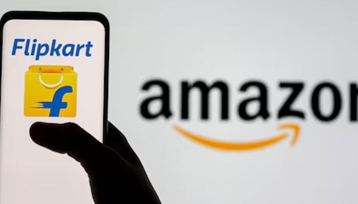 Smartphone with Flipkart logo is seen in front of displayed Amazon logo in this image.— Reuters/File