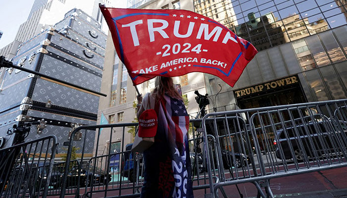 A person waves a Trump flag outside Trump Tower, after US President-elect Donald Trump won the presidential election, in New York City, US, on November 6, 2024. — Reuters