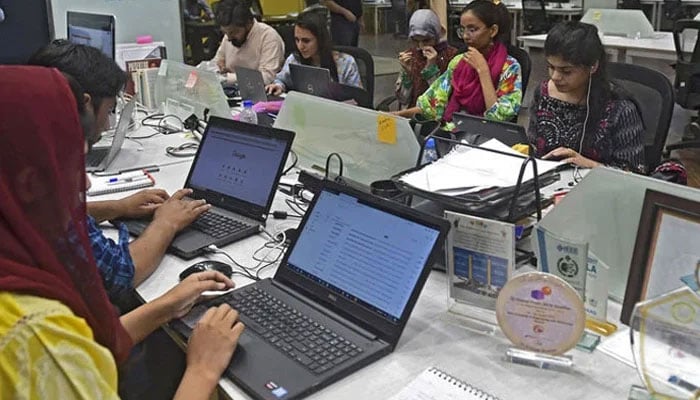 People work at their stations at the National Incubation Centre (NIC). — AFP/File