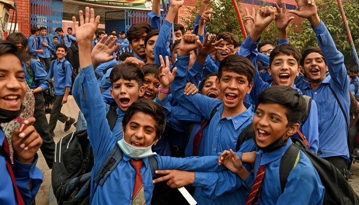 Students gesture as they leave after attending their school in Lahore on November 6, 2024. — AFP