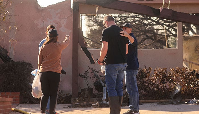 People react near houses that were damaged in the Mountain Fire in Camarillo, US on  November 7, 2024. — Reuters